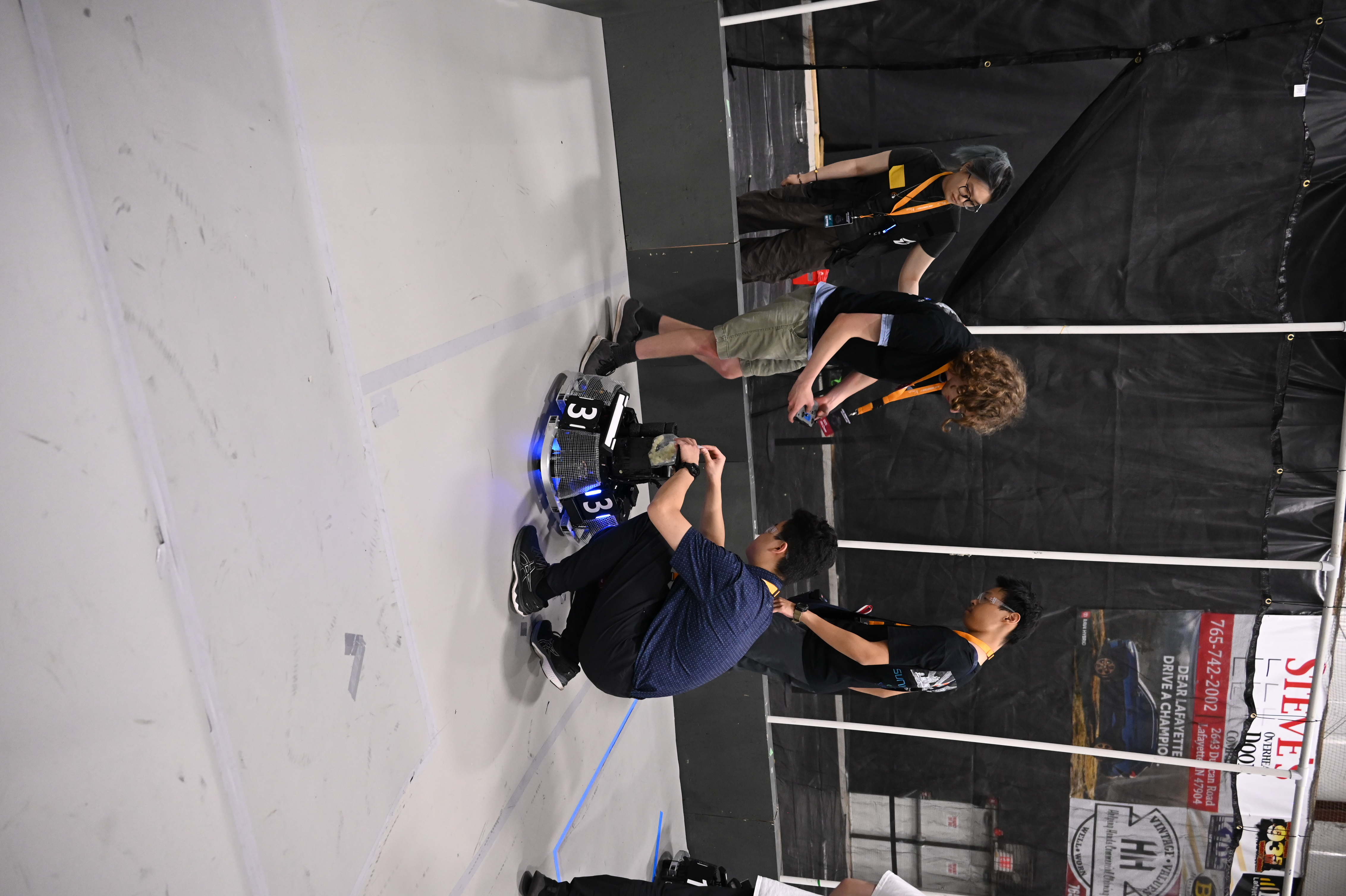 Team member servicing a robot on the competition field